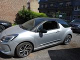 a small silver car parked on the side of the street