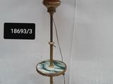 a lamp that is on a stand with a pink shade