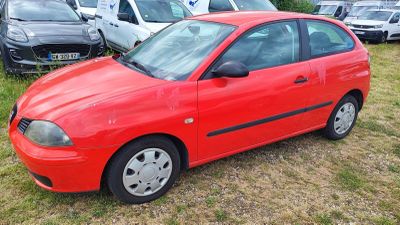 a red car that is parked in the grass