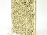 yellow and black speckled notebook on clear acrylic stand