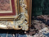 a picture of a picture of a gold frame on a carpet
