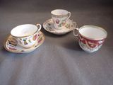 three cups and saucers are sitting on a table