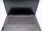 a laptop with a keyboard on it sitting on a table