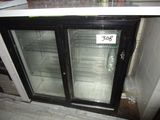 a refrigerator with two glass doors and a price tag on it