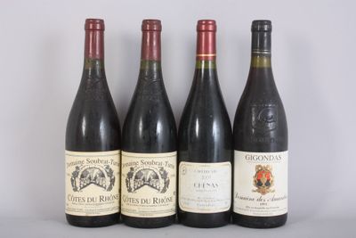 four bottles of wine are lined up on a table