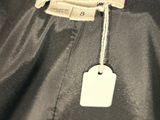 a close up of a black jacket with a tag on it