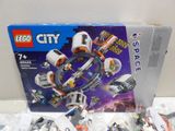 a box of lego city space station set on the table