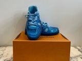 a close up of a pair of blue shoes on a box