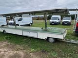 many vans that are parked in the grass