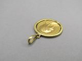 an image of a gold coin with a face on it