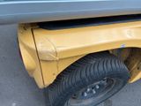 a close up of a car with a tire on the ground