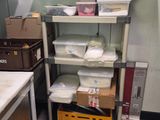 a small kitchen with a lot of boxes on the shelves
