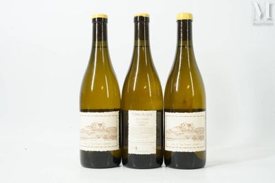 three bottles of wine sitting on top of a white table
