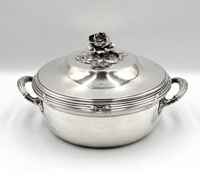 a silver plated casserole with a flower on top