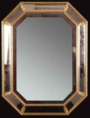 an image of a mirror with a gold frame on a black background