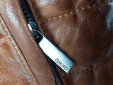 a close up of a brown leather jacket with a name tag on it