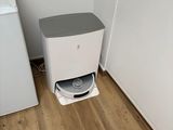 a small white refrigerator next to a small white washing machine