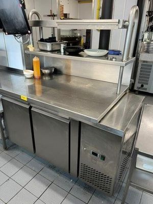 a large stainless steel counter in a commercial kitchen