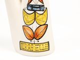 a white vase with a picture of a bird on it