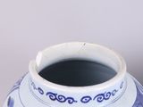 a blue and white vase sitting on a table