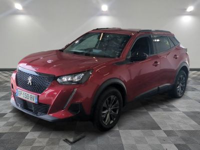 the red suv is parked in a large room with a checkered floor