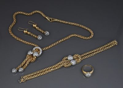a collection of gold and diamond jewelry including a necklace, bracelet, and ring