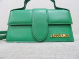 a green purse that has a name on it