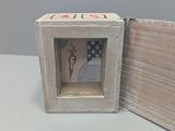 a small wooden box with a picture inside of it