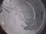 a silver plate with a map on it on a table