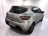 the rear end of a silver car in a white room