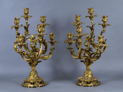 pair of antique brass candelabs with flowers and leaves