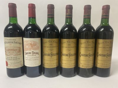 six bottles of wine are lined up in a row on a white surface