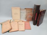 several old books sitting on top of each other on a table