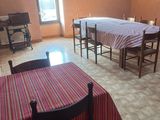 many tables and chairs in a room with a red and white table cloth