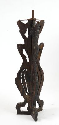a large metal vase that is standing on a stand