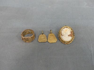 three gold rings and a ring with a picture of a woman