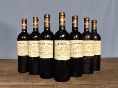 six bottles of wine sitting on top of a wooden table
