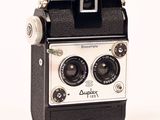 a black and white photo of an old camera