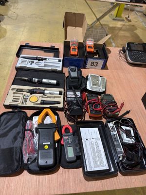 a table with a lot of electronics and other items on it