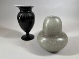 two vases sitting next to each other on a table