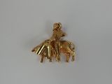 a gold plated elephant with a rider on it ' s back