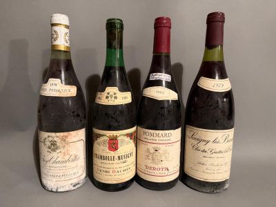 four bottles of wine are lined up on a table