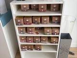 a white bookcase with lots of boxes on top of it