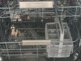 a dishwasher that has a lot of dishes inside of it