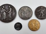 four different types of coins are shown on a white surface