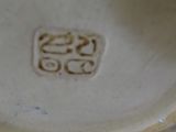 a close up of a white plate with a brown design