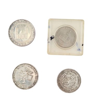 four different types of silver coins are shown in a small box