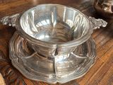 a silver bowl sitting on top of a wooden table