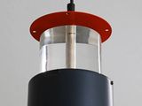 a close up of a black and red light hanging from a ceiling