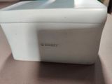 a small white box with a lid sitting on a table